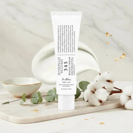 Dr. Althea Relief Cream tube on marble with cotton, luxury skincare background